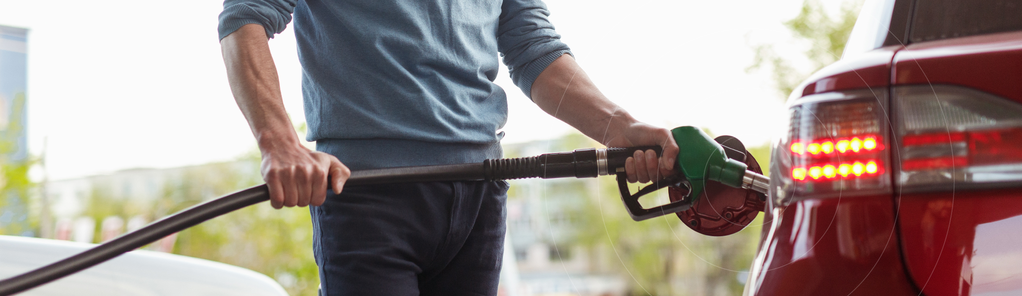 man staat bij tankstation en is zijn auto vol aan het tanken en gebruikt een tankpas